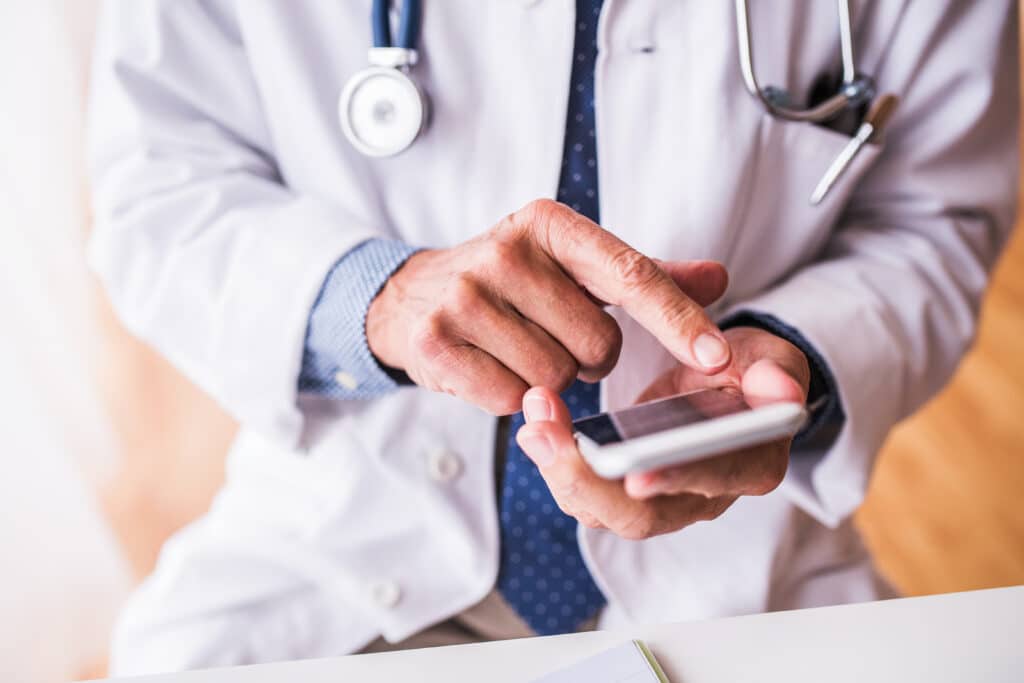 Doctor sending out appointment text message