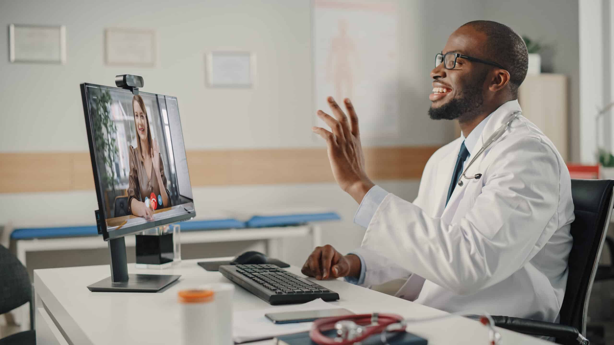 Physician is Making a Video Call with a Female Patient on Desktop Computer
