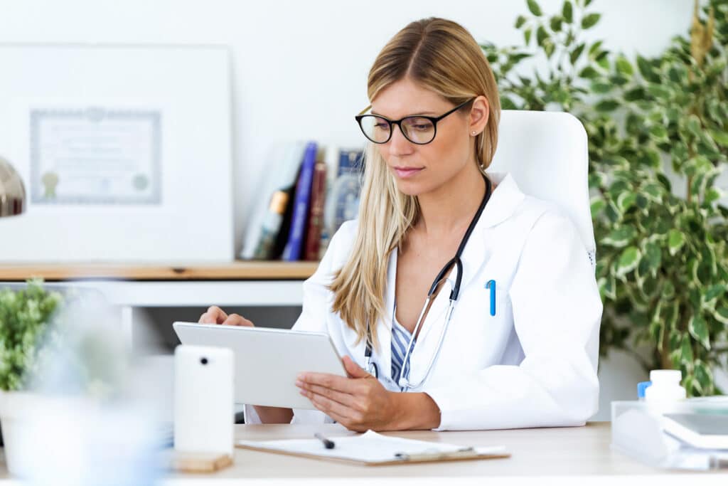 How AI Document Analysis Improves Efficiency Shot of female doctor using her digital tablet in the consultation.