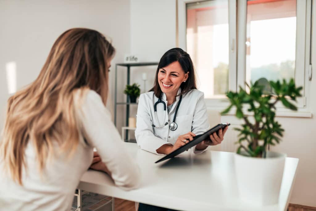 Female doctor explaining diagnosis to her young patient.