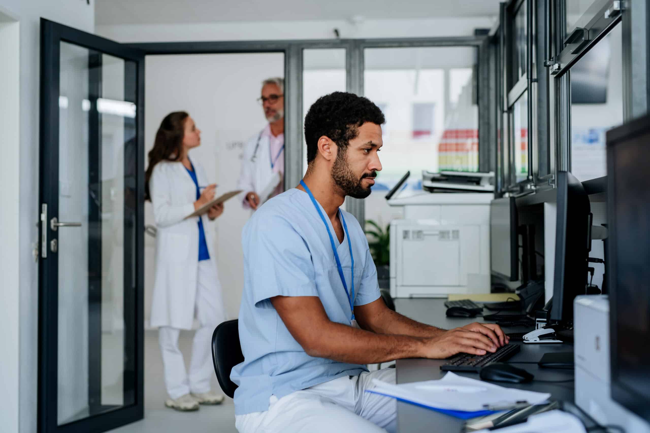 Young doctor working on computer in the hospital office.