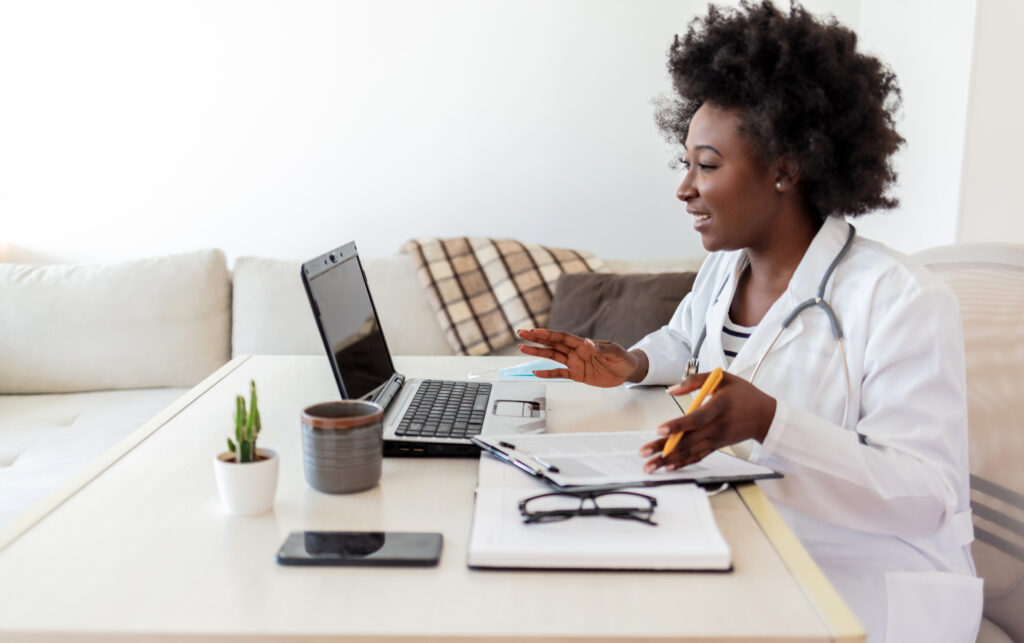 physician conducting telehealth consultation via laptop