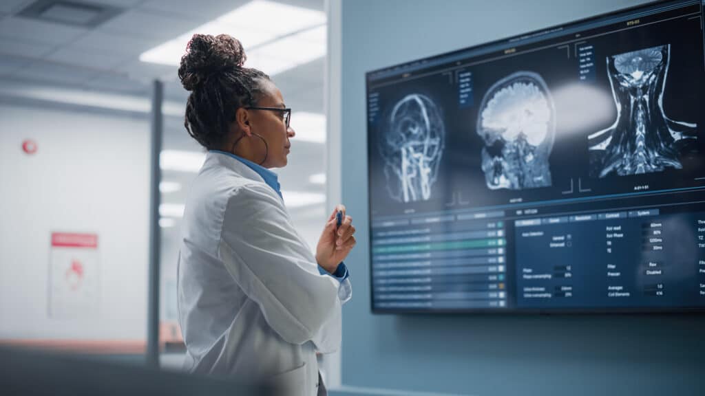 Doctor reviewing patient data on a computer screen.