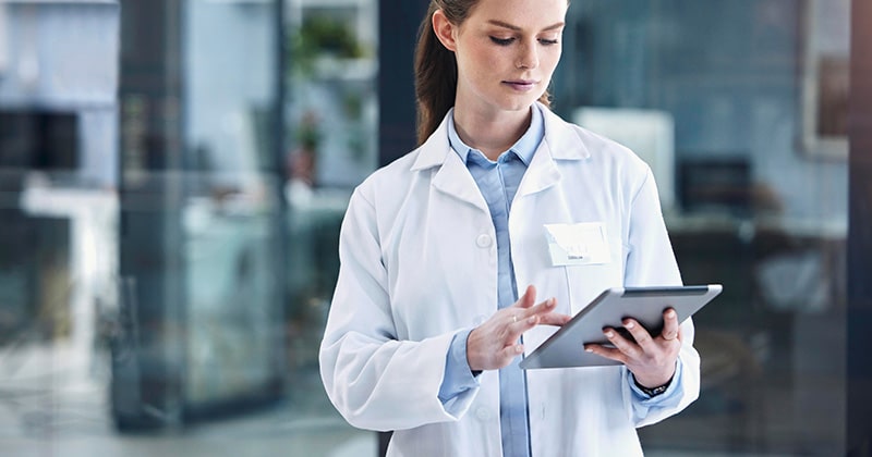 Doctor reviewing AI-optimized charge capture data.