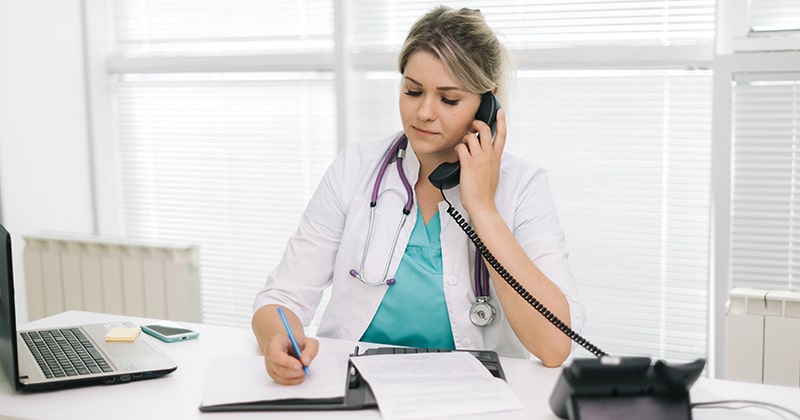 Doctor reviewing branded patient information packet