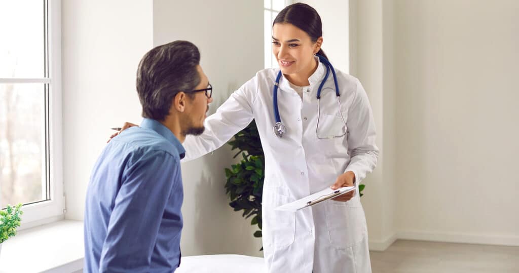 Doctor reviewing branded patient information packe