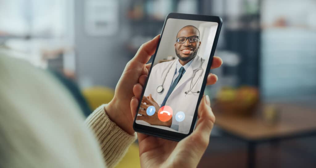 A healthcare provider demonstrating a telehealth platform during a virtual consultation