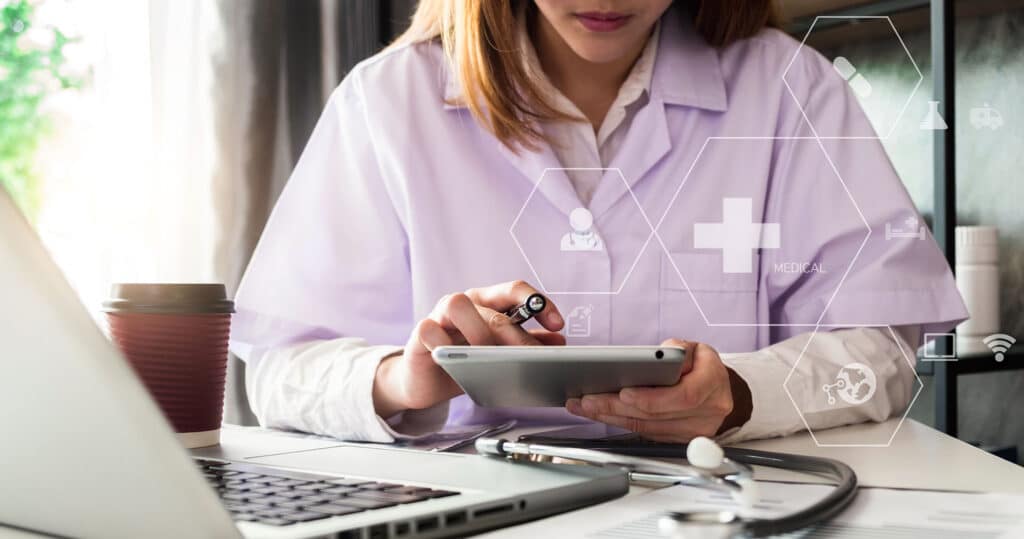 Doctor inputting patient information for charge capture