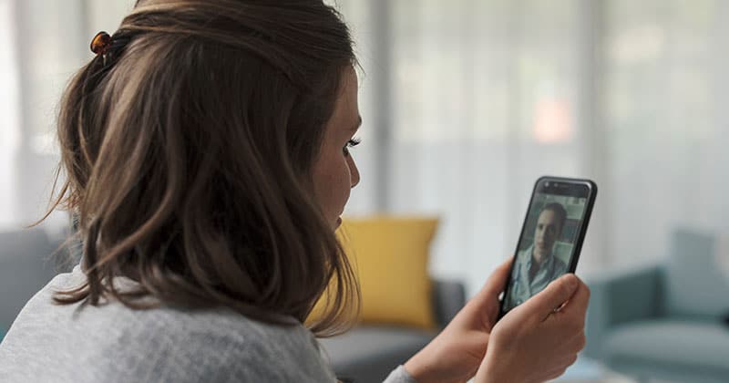 Person using telehealth app for mental health support