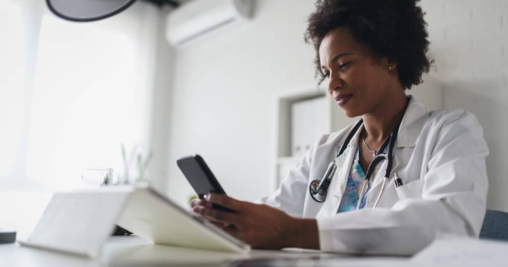 Healthcare provider reviewing patient data through a telehealth platform.
